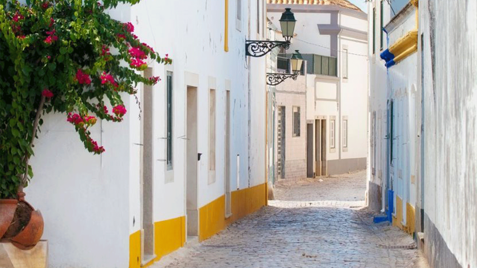 A quiet, white-washed street in Faro, Portugal